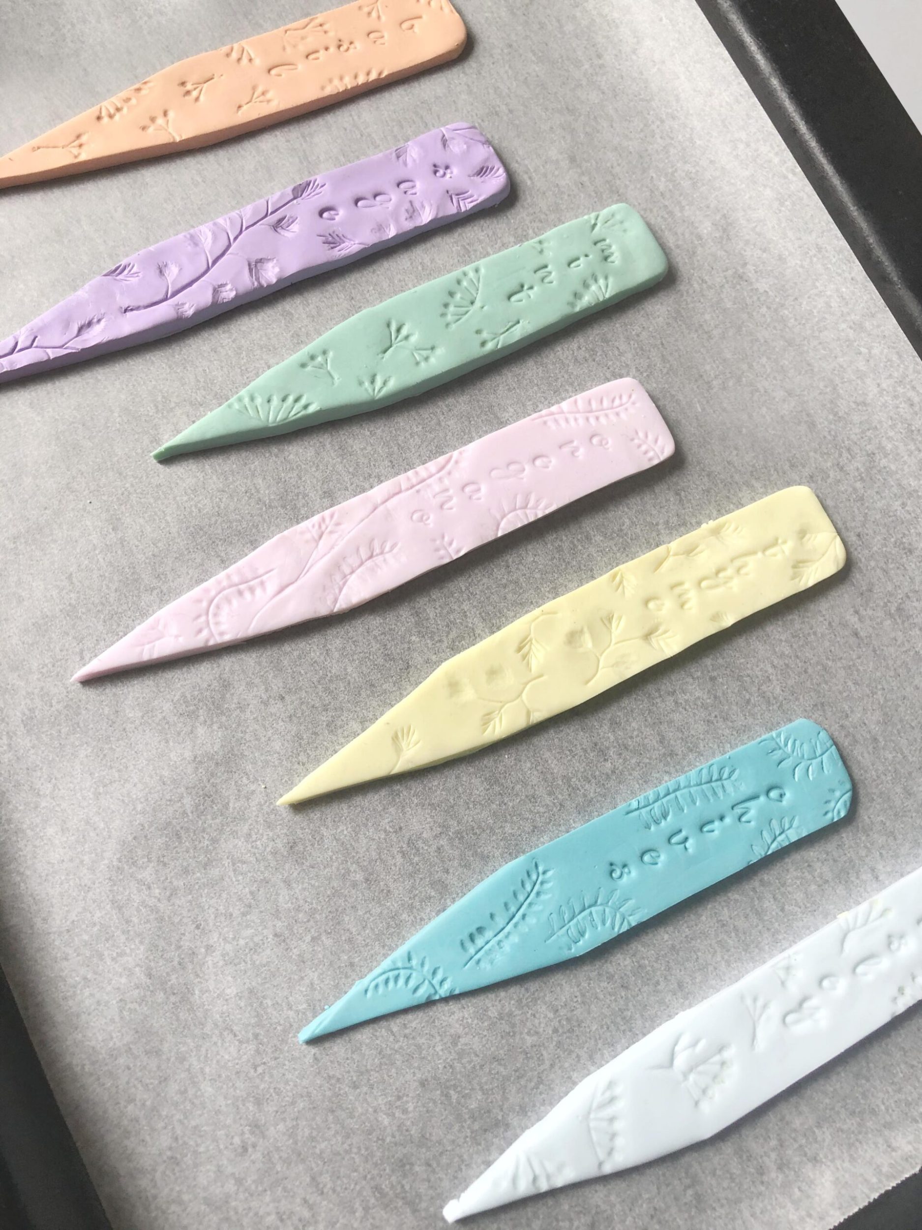 Multicoloured slices of clay on an oven tray